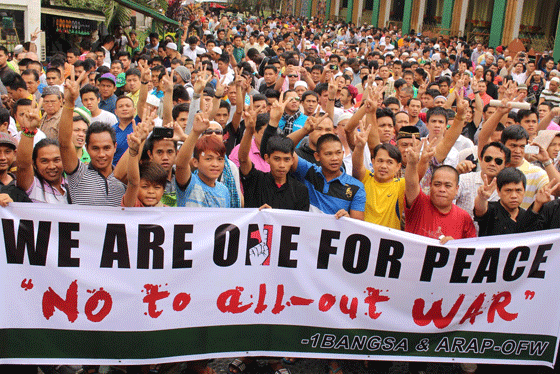 Hundreds from Muslim communities in Metro Manila flash the peace sign on Friday as they hold a rally for peace at the Quiapo Mosque in Manila. The mass action must have been prompted by an apparent fallout from the Mamasapano (Maguindanao) incident on January 25 where 44 police commandos were reported to have been ambushed and killed by Muslim separatist rebels. PHOTO BY RUY L. MARTINEZ 