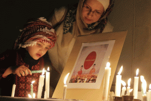 SYMPATHIES FROM JORDAN  Jordanians take part in a candle light vigil to condemn the killing of the two Japanese hostages, Haruna Yukawa and Kenji Goto, by the Islamic State (IS) group and to show support for the people of Japan, on Tuesday outside the Japanese embassy in Amman. The IS is threatening to kill a Jordanian pilot it is holding captive. AFP PHOTO