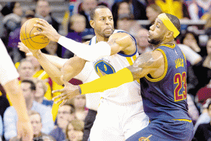 Andre Iguodala No.9 of the Golden State Warriors looks for a pass while under pressure from LeBron James No.23 of the Cleveland Cavaliers during the second half at Quicken Loans Arena in Cleveland, Ohio.  AFP PHOTO