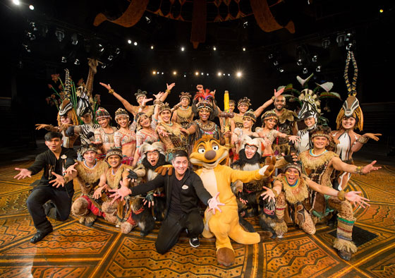 ■ HKDL choreographer Jaime Del Prado (seated center) with the cast of ‘The Festival of the Lion King’ 