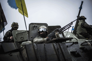 READY TO FIGHT  Ukrainian soldiers are seen in an armored vehicle topped with a Ukrainian flag near the city of Artemivsk, in the Donetsk region, before heading to the city of Debaltseve about 45 kilometers away, on Monday. AFP PHOTO