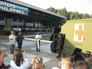 Defense Secretary Voltaire Gazmin and AFP Chief of Staff Gen. Gregorio Pio Catapang look on as the command chaplain leads a prayer during the blessing of the Humvees