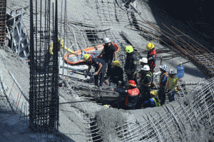 CRUSHED  Rescuers retrieve one of the bodies of two workers who died. Eleven workers were also injured in the incident. PHOTO BY RENE H. DILAN