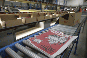 BACK IN ACTION  The forthcoming edition of the weekly newspaper Charlie Hebdo is pictured on Tuesday rolling out of a printing press in Villabe, south of Paris. AFP PHOTO