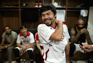 Manny Pacquiao laughs before a basketball game between Kia and Talk and Text in Manila on Wednesday. Pacquiao declared himself an enemy of doping on February 25, ahead of a megabucks bout with unbeaten Floyd Mayweather, his longtime rival as the planet’s best “pound-for-pound” fighter. AFP PHOTO