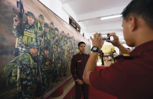 ART OF WAR  A cadet of the Philippine national Police academy has his picture taken before a mural of ‘Fallen 44’ which refers to the fatalities in the January 25 mamasapano incident.  PhOTO By MeLyn AcOsTA 