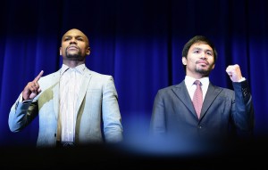 Boxers Floyd Mayweather and Manny Pacquiao pose for the audience on Thrusday in Los Angeles, California at the Floyd Mayweather vs Manny Pacquiao press conference ahead of their May 2, 2015 fight in Las Vegas.  AFP PHOTO 