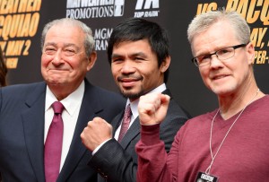 Boxer Manny Pacquiao (C), trainer Freddie Roach (L) and promoter Bob Arum arrive for a joint press conference with Floyd Mayweather Jr  on March 11, 2015 at the Nokia Theatre at LA Live in Los Angeles, California.  AFP PHOTO