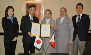 Japanese Ambassador Kazuhide Ishikawa congratulates Sister Merceditas Ong after signing the grant contract for St. Paul University’s project. 