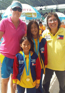 Philippine Swimming League President Susan Papa poses with Aubrey Tom (second to the left) and Kyla Soguilon after the awarding of medals in the 50m backstroke of 2015 Phuket International Swimming Championship on Saturday at the Thanyapura Sports and Leisure Center in Thailand. CONTRIBUTED PHOTO