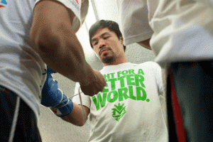 Manny Pacquiao dons gloves prior to sparring. AFP FILE PHOTO