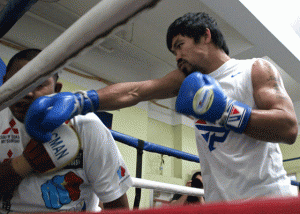 Manny Pacquiao throws a light punch against assistant trainer Buboy Fernandez during training. AFP FILE PHOTO