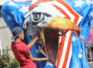 GETTING READY  A man rushes work on a huge effigy of an eagle that will be used by militant groups in their march from Liwasang Bonifacio to Mendiola today. PHOTO BY MELYN ACOSTA