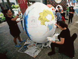 Art students paint their favorite fairy tales on giant eggs, which will be hidden for families to hunt on Easter Sunday PHOTO BY MIGUEL DE GUZMAN