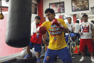 Manny Pacquiao hits the heavy bag during training. AFP FILE PHOTO