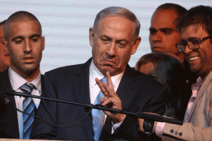 VICTORIOUS  Israeli Prime Minister Benjamin Netanyahu gestures to supporters as reacts to exit poll figures in Israel’s parliamentary elections late on Tuesday in the city of Tel Aviv. Netanyahu claimed victory in elections as exit polls put him neck-andneck with center-left rivals after a late fightback in his bid for a third straight term. AFP PHOTO