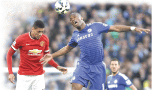 Chelsea’s Ivorian striker Didier Drogba (right) goes up for a header against Manchester United’s English defender Chris Smalling (left) during the English Premier League football match between Chelsea and Manchester United at Stamford Bridge in London.  AFP PHOTO 