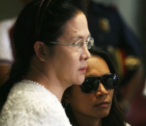 I’M A VICTIM TOO Maria Kristina Sergio (in dark glasses), the suspected recruiter of Mary Jane Veloso, together with Public Attorney’s Office chief Persida Rueda Acosta at the PNP general headquarters in Camp Crame, Quezon City. PHOTO BY MIGUEL ANTONIO DE GUZMAN