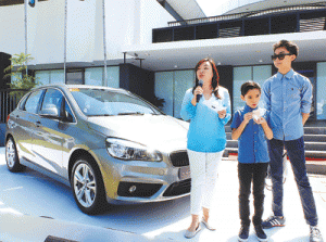 BMW Philippines president Maricar Parco (left) presents the new BMW Series 2 Active Tourer together with her sons Alfonso (center) and Anton