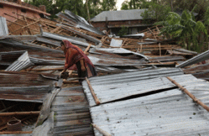 DEVASTATION TRAIL A Bangladeshi victim gathers her belongings near her home which was destroyed during storms in Bogra some 200 kms from Dhaka. Powerful storms swept Bangladesh at the weekend leaving a trail of devastation in the country’s northwest and killing at least 35 people, officials said on Monday. AFP PHOTO