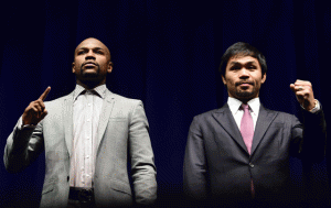 Manny Pacquiao (right) and Floyd Mayweather Jr. gesture while posing during a press conference in Los Angeles, California. AFP PHOTO