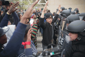 MARYLAND PROTEST Protesters hold up their hands as they stand off with police during a march in honor of Freddie Gray on Sunday in Baltimore, Maryland. AFP PHOTO