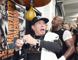 HORSEPLAY  Cutman Rafael Garcia (left) reacts after putting tape over the eyes and mouth of an image of WBO welterweight champion Manny Pacquiao as WBC/WBA welterweight champion Floyd Mayweather Jr. (right) gets ready to hit a speed bag during a workout at the Mayweather Boxing Club on Wednesday in Las Vegas, Nevada. AFP PHOTO