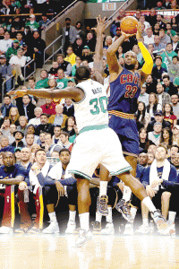 LeBron James No.23 of the Cleveland Cavaliers takes a shot over Brandon Bass No.30 of the Boston Celtics during the second quarter in the first round of the 2015 NBA Playoffs at TD Garden in Boston, Massachusetts.  AFP PHOTO