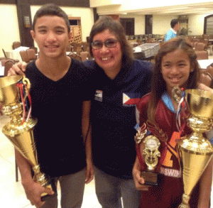 Philippine Swimming League President Susan Papa (center) and Swimmers of the Year Sean Terence Zamora (left) and Kyla Soguilon. CONTRIBUTED PHOTO