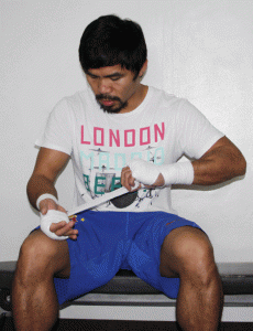 Manny Pacquiao wraps his hand in preparation for practice. AFP FILE PHOTO