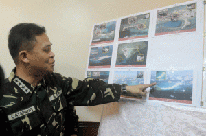 WORST NIGHTMARE Gen. Gregorio Catapang shows  photos taken on December 13, 2014 and on April 2, 2015 of  what is claimed to be an under-construction airstrip at the top end of Fiery Cross Reef. AFP PHOTO / CSIS Asia Maritime Transparency Initiative / DigitalGlobe