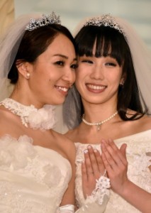 Japanese actress Akane Sugimori (right) and her partner Ayaka Ichinose, both dressed in white, display their wedding rings at a press conference after their marriage ceremony in Tokyo. AFP PHOTO