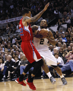 Kawhi Leonard #2 of the San Antonio Spurs drives against Matt Barnes #22 of the Los Angeles Clippers in Game 3 of the Western Conference quarterfinals during the 2015 NBA Playoffs at the AT&T Center in San Antonio, Texas. AFP PHOTO