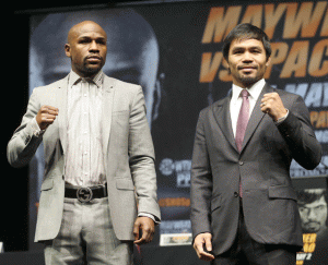 Floyd Mayweather Jr. (left) and Manny Pacquiao strike a pose during a press conference. AFP FILE PHOTO