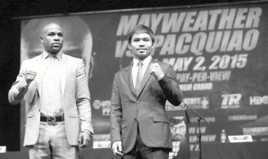 Floyd Mayweather Jr. (left) and Manny Pacquiao pose for a photo during a press conference.  AFP PHOTO