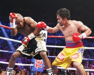 Pushed to a corner Manny Pacquiao drives Floyd Mayweather Jr. to the ropes during their “Fight of the Century” in Las Vegas on Saturday (Sunday, Philippine time). Mayweather won via unanimous decision, a verdict that broke the hearts not only of Filipinos but also of Pacquiao’s millions of fans around the world. No rematch has been talked about. AFP PHOTO