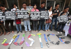 CRY FOR JUSTICE Co-workers, friends, and bereaved families of the 72 Kentex Manufacturing Inc. workers who perished in a deadly factory fire cry for justice after they buried the fatalities at Arkong Bato cemetery in Valenzuela City on Friday. PHOTO BY RENE H. DILAN 