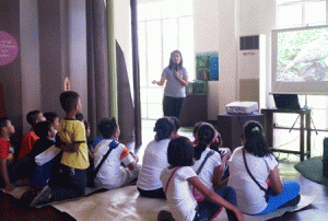 Ana Almazar talks about the Zebra Dove (Geopelia striata) with children at Museo Pambata