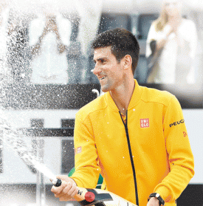 Novak Djokovic of Serbia sprays Champagne after winning the men’s final match against Swiss Roger Federer at the ATP Tennis Open at the Foro Italico in Rome.  AFP PHOTO