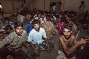 ‘UNWANTED’ MINORITY  A group of rescued migrants mostly Rohingya migrants from Myanmar and Bangladesh, passengers of the first migrants boat, are temporarily housed at a government sports auditorium in Lhoksukon in Aceh province on May 11, 2015 after Indonesian rescuers found their boat stranded in waters off north Aceh province, an official said. Four boats carrying some 1,400 Rohingya migrants were rescued off the coasts of Indonesia and Malaysia on Monday, officials said, a day after nearly 600 others arrived in a wooden vessel off Indonesia’s Aceh. AFP PHOTO