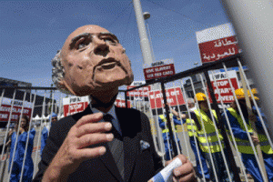 A demonstrator disguised as FIFA President Sepp Blatter takes part in a protest against the condition of workers in Qatar, on the sidelines of the 65th FIFA Congress in Zurich. AFP PHOTO