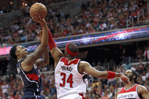 Jeff Teague, No.0 of the Atlanta Hawks, puts up a shot over Paul Pierce No.34 of the Washington Wizards during the second half in Game Four of the Eastern Conference semifinals of the 2015 NBA playoffs at Verizon Center in Washington, D.C. The Atlanta Hawks won, 106-101. AFP PHOTO