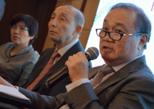 Manuel Pangilinan (right), chairman of the Philippine Long Distance Telephone Co. (PLDT), gestures during the 2015 First Quarter Financial and Operating Results press briefing as Napoleon Nazareno (center), CEO of Smart Communication, and Anabelle Chua (left), senior vice president looks on. AFP PHOTO