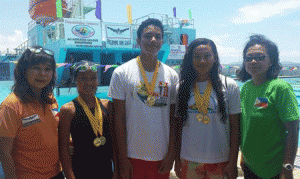 (From left) Philippine Swimming League (PSL) Secretary General Maria Susan Benasa, gold medalists Isis Arnaldo, Peter James Hernandez and Trisha Oliveros, and PSL Regional Director lawyer Ma. Theresa Mahiwo. CONTRIBUTED PHOTO