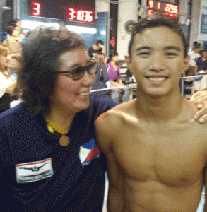 Philippine Swimming League President Susan Papa congratulates Sean Terence Zamora after breaking the boys’14 years 100m backstroke record in the 2015 Hong Kong Stingrays Swimming Championships. CONTRIBUTED PHOTO