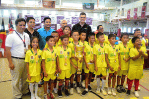 Two-time U-11 champion San Ildefonso Parish happily poses with Ambassadors Cup Task Force head Rene Ledesma, Gawad Kalinga Sipag Program volunteer director Kevin Goco, Team Socceroo Football Club manager Nicholas Reyes, UA&P president Dr. Jose Maria Mariano, Ambassador of South Africa to the Philippines Martin Slabber, and South Africa Embassy’s Political Counsellor Tshire Kau