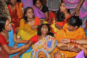 A woman is comforted by relatives and friends after the death of her husband on the outskirts of Patna on Tuesday after a new 7.3 earthquake and several powerful aftershocks hit neighboring devastated Nepal. AFP PHOTO