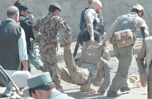 SUNDAY ATTACK Foreign security forces carry a colleague who was a victim of a suicide attack in Kabul. A powerful suicide blast struck near Kabul airport during the peak morning rush hour on Sunday, killing three persons. AFP