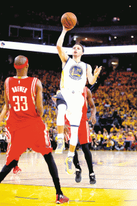 HANG TIME Stephen Curry No. 30 of the Golden State Warriors shoots against Corey Brewer No. 33 of the Houston Rockets in the second half during game two of the Western Conference Finals of the 2015 NBA Playoffs at Oracle Arena in Oakland,California.  AFP PHOTO  