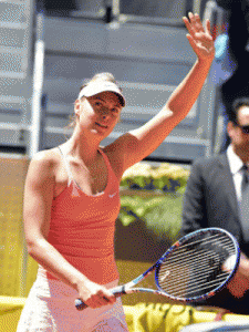 Maria Sharapova waves to supporters as she celebrates her victory over French tennis player Caroline Garcia during the Madrid Open tournament at the Caja Magica (Magic Box) sports complex in Madrid on May 6, 2015. AFP PHOTO